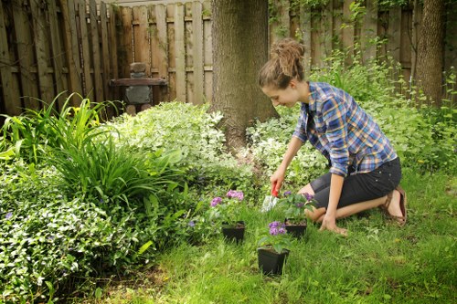 Worker wearing PPE operating a ride-on mower safely